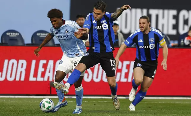 New York City FC's Tayvon Gray, left, fights for the ball with CF Montreal's Luca Petrasso, center, during an MLS soccer match Saturday, May 10, 2025, in New York. (AP Photo/Andres Kudacki)