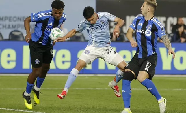 New York City FC's Agustin Ojeda, center, fights for the ball with CF Montreal's Dante Sealy, left, and Hannes Wolf, right, during an MLS soccer match on Saturday, May 10, 2025, in New York. (AP Photo/Andres Kudacki)