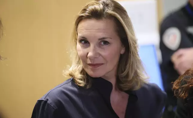 A plaintiff speaks with the media outside a Paris court, after a verdict was delivered on accusations that French actor Gerard Depardieu sexually assaulted two women who were working on a film with him in 2021, in Paris, Tuesday, May 13, 2025. (AP Photo/Thomas Padilla)