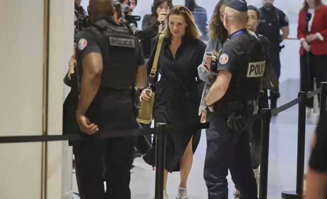 A plaintiff arrives in a Paris court, which is set to deliver a verdict on accusations that French actor Gerard Depardieu sexually assaulted two women who were working on a film with him in 2021, in Paris, Tuesday, May 13, 2025. (AP Photo/Thomas Padilla)