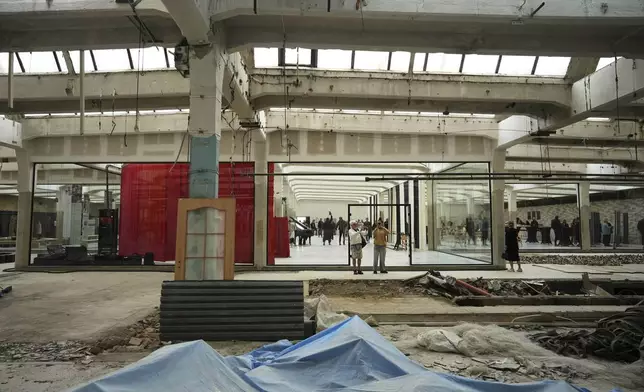 Visitors walk around the Museum of Survivors, located in a factory where Oskar Schindler saved some 1200 Jews during WWII, in Brnenec, Czech Republic, Saturday, May 10, 2025. (AP Photo/Petr David Josek)