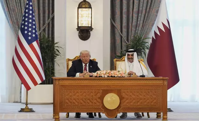 President Donald Trump and Qatar's Emir Sheikh Tamim bin Hamad Al Thani attend a signing ceremony at the Amiri Diwan in Doha, Qatar, Wednesday, May 14, 2025. (AP Photo/Alex Brandon)
