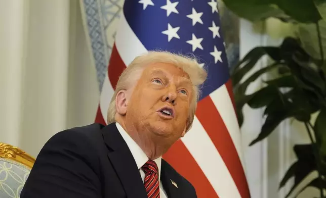 President Donald Trump gestures as meets Qatar's Emir Sheikh Tamim bin Hamad Al Thani at the Amiri Diwan in Doha, Qatar, Wednesday, May 14, 2025. (AP Photo/Alex Brandon)