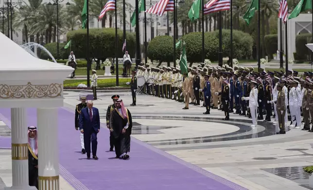 President Donald Trump and Saudi Crown Prince Mohammed bin Salman walk during an arrival ceremony at the Royal Palace in Riyadh, Saudi Arabia, Tuesday, May 13, 2025. (AP Photo/Alex Brandon)
