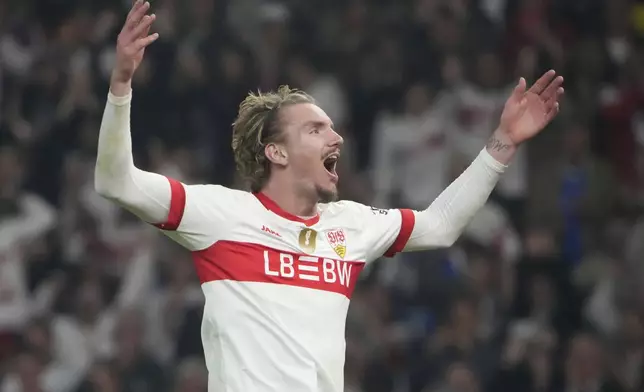 Stuttgart's Nick Woltemade celebrates after winning the trophy in the German soccer cup, DFB Pokal, final match between Arminia Bielefeld and VfB Stuttgart at Olympiastadion in Berlin, Germany, Saturday, May 24, 2025. (AP Photo/Matthias Schrader)