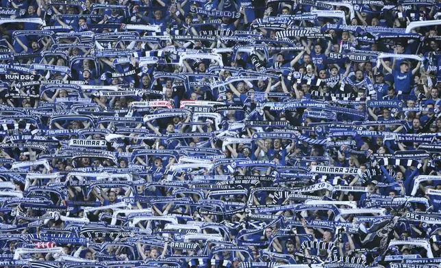 Arminia Bielefeld fans cheer ahead of the German soccer cup, DFB Pokal, final match between Arminia Bielefeld and VfB Stuttgart at Olympiastadion in Berlin, Germany, Saturday, May 24, 2025. (AP Photo/Matthias Schrader)
