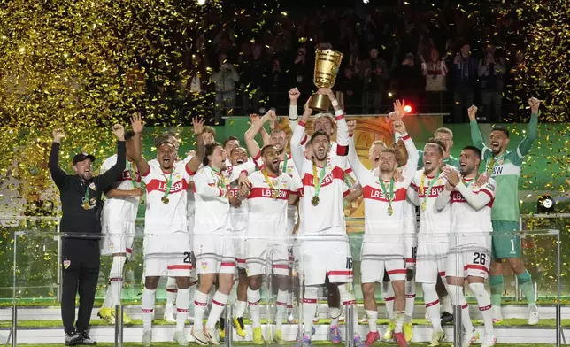 VfB Stuttgart players celebrate after winning the trophy in the German soccer cup, DFB Pokal, final match between Arminia Bielefeld and VfB Stuttgart at Olympiastadion in Berlin, Germany, Saturday, May 24, 2025. (AP Photo/Matthias Schrader)