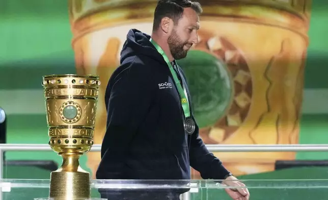 Arminia Bielefeld head coach Michel Kniat walks away with his second place medal after the German soccer cup, DFB Pokal, final match between Arminia Bielefeld and VfB Stuttgart at Olympiastadion in Berlin, Germany, Saturday, May 24, 2025. (AP Photo/Matthias Schrader)