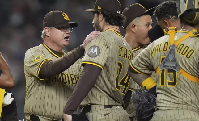 San Diego Padres manager Mike Shildt, left, talks to pitcher Dylan Cease before Cease leaves during the seventh inning of a baseball game against the New York Yankees Wednesday, May 7, 2025, in New York. (AP Photo/Frank Franklin II)