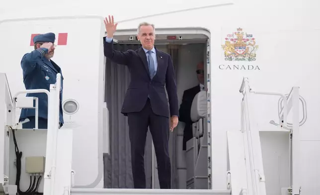 Canadian Prime Minister Mark Carney boards a government plane in Ottawa, Ontario, Monday, May 5, 2025, en route to Washington for a meeting with U.S. President Donald Trump on Tuesday. (Adrian Wyld/The Canadian Press via AP)