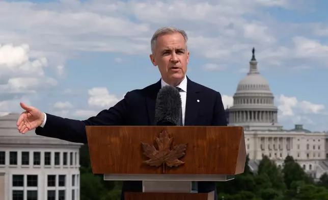 Canada's Prime Minister Mark Carney gestures as he responds to a reporter's question during a news conference at the Canadian embassy in Washington, Tuesday, May 6, 2025. (Adrian Wyld/The Canadian Press via AP)