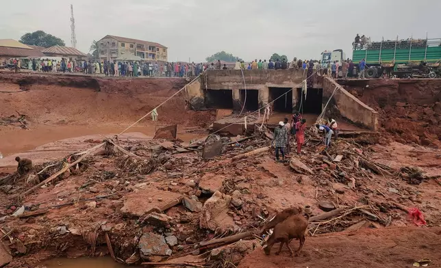 People search in flooded area following a downpour in Mokwa, Nigeria, Friday, May 30, 2025. (AP Photo/Chenemi Bamaiyi)