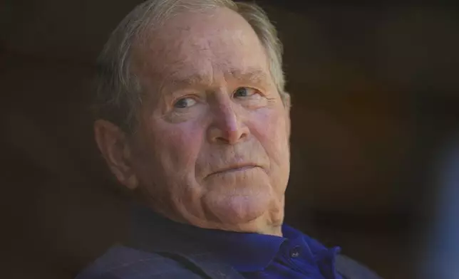 Former U.S. President George W. Bush watches the third inning of a baseball game between the Texas Rangers and the Seattle Mariners Sunday, May 4, 2025, in Arlington, Texas. (AP Photo/Julio Cortez)