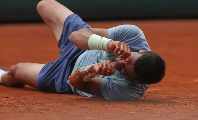 Bosnia and Herzegovina's Damir Dzumhur grimaces in pain after falling during his second round match of the French Tennis Open against France's Giovanni Mpetshi Perricard, at the Roland-Garros stadium, in Paris, Wednesday, May 28, 2025. (AP Photo/Lindsey Wasson)