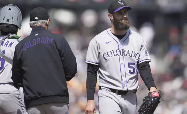 Colorado Rockies pitcher Jake Bird, right, walks toward the dugout as manager Bud Black, left, makes a pitching change during the seventh inning of a baseball game against the San Francisco Giants in San Francisco, Saturday, May 3, 2025. (AP Photo/Jeff Chiu)