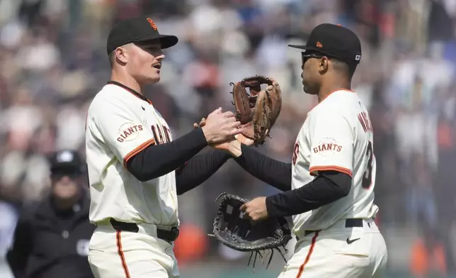 San Francisco Giants third baseman Matt Chapman, left, celebrates with first baseman LaMonte Wade Jr. after a baseball game against the Colorado Rockies in San Francisco, Saturday, May 3, 2025. (AP Photo/Jeff Chiu)