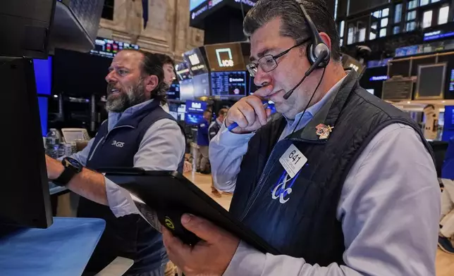 Specialist Michael Pistillo, left, and trader Michael Capolino work on the floor of the New York Stock Exchange, Tuesday, May 27, 2025. (AP Photo/Richard Drew)