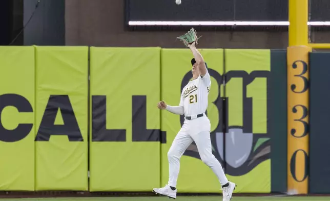 Athletics outfielder Tyler Soderstrom catches a fly ball during the fifth inning of a baseball game against the Philadelphia Phillies, Friday, May 23, 2025, in West Sacramento, Calif. (AP Photo/Sara Nevis)