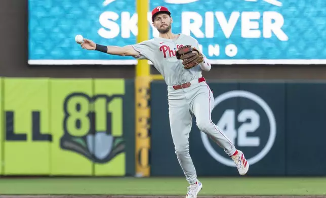 Philadelphia Phillies shortstop Trea Turner throws to first base for an out during the third inning of a baseball game against the Athletics, Friday, May 23, 2025, in West Sacramento, Calif. (AP Photo/Sara Nevis)