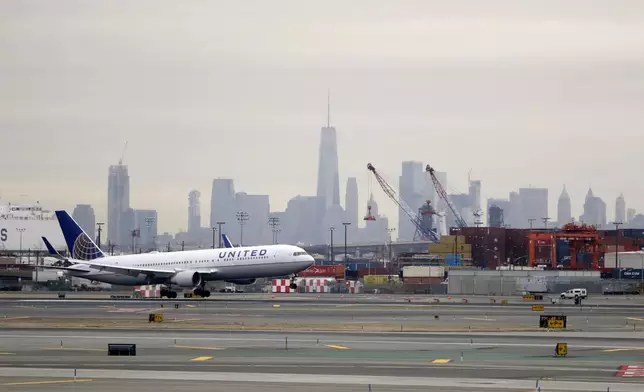 FILE - A United Airlines jet prepares touches down at Newark Liberty International Airport a day after a temporary grounding of aircraft was placed after reports of drones in the flight path, Wednesday, Jan. 23, 2019, in Newark, N.J. (AP Photo/Julio Cortez, File)