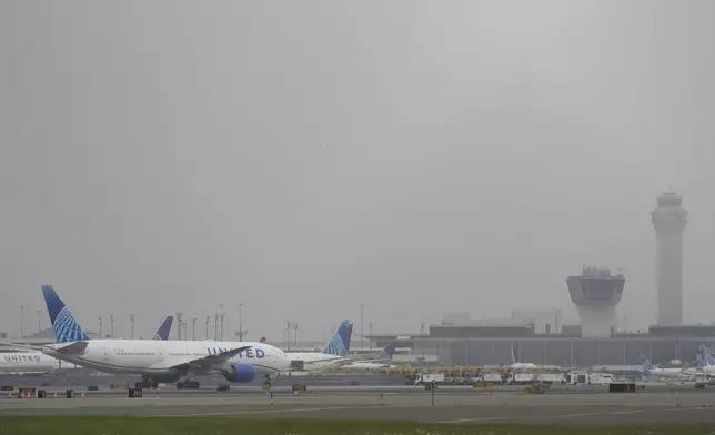 Fog covers planes and control towers at Newark Liberty International Airport in Newark, N.J., Monday, May 5, 2025. (AP Photo/Seth Wenig)