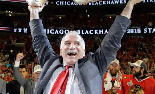 FILE - Chicago Blackhawks' head coach Joel Quenneville hoists the Stanley Cup after defeating the Tampa Bay Lightning in Game 6 of the NHL hockey Stanley Cup Final series on Wednesday, June 10, 2015, in Chicago. (AP Photo/Nam Y. Huh, File)