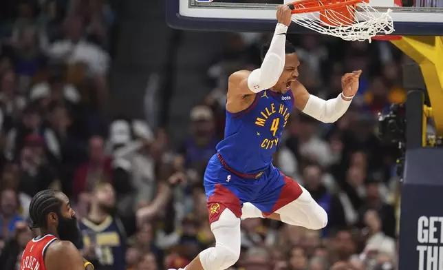 Denver Nuggets guard Russell Westbrook, right, reacts after dunking the ball for a basket as Los Angeles Clippers guard James Harden looks on in the second half of Game 1 of an NBA first-round playoff series Saturday, April 19, 2025, in Denver. (AP Photo/David Zalubowski)