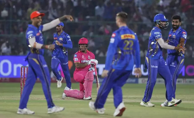 Mumbai Indians players celebrates the dismissal of Rajasthan Royals' Shimron Hetmyer, center kneeling, during the Indian Premier League cricket match between Rajasthan Royals and Mumbai Indians at Sawai Mansingh Stadium in Jaipur, India, Thursday, May 1, 2025. (AP Photo/Surjeet Yadav)