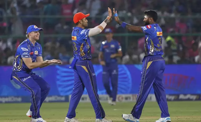 Mumbai Indians' captain Hardik Pandya, right, celebrates the dismissal of Rajasthan Royals' Shubham Dubey with teammates during the Indian Premier League cricket match between Rajasthan Royals and Mumbai Indians at Sawai Mansingh Stadium in Jaipur, India, Thursday, May 1, 2025. (AP Photo/Surjeet Yadav)