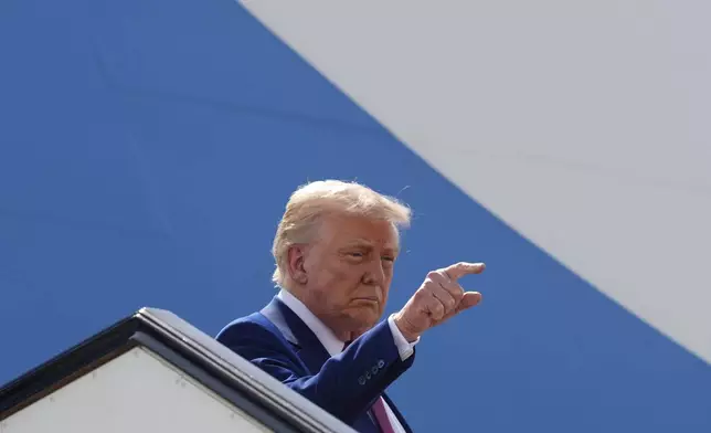 President Donald Trump gestures as he boards Air Force One to depart Al Udeid Air Base, Thursday, May 15, 2025, in Doha, Qatar. (AP Photo/Alex Brandon)
