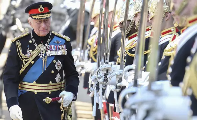 Britain's King Charles III inspects members of the Household Cavalry during the presentation of the New Standards at Windsor Castle, Windsor, England, Monday May 12, 2025. (Chris Jackson/Pool via AP)