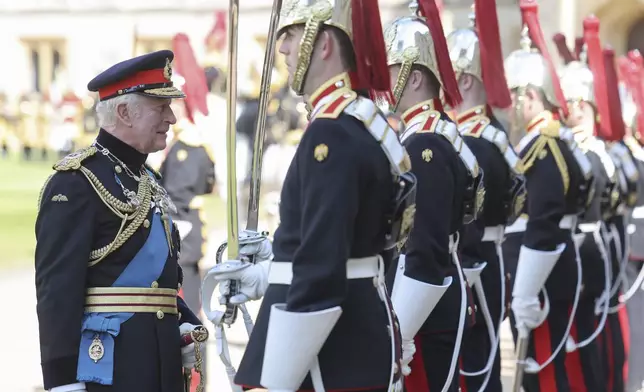 Britain's King Charles III inspects members of the Household Cavalry during the presentation of the New Standards at Windsor Castle, Windsor, England, Monday May 12, 2025. (Chris Jackson/Pool via AP)