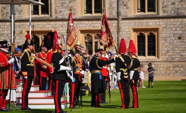 Britain's King Charles III, center right, Princess Anne, center left, attend the presentation of the New Standards at Windsor Castle, Windsor, England, Monday May 12, 2025. (Aaron Chown/Pool via AP)