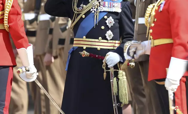 Britain's King Charles III salutes military personnel at the presentation of the New Standards at Windsor Castle, Windsor, England, Monday May 12, 2025. (Chris Jackson/Pool via AP)