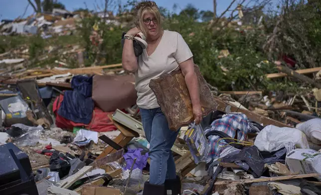 Edwina Wilson stands in what is left of her destroyed home, Sunday, May 18, 2025, in London, Ky., after a severe storm passed through the area. (AP Photo/Carolyn Kaster)