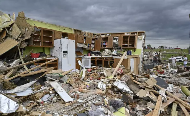 The remains of a kitchen surrounded by debris after severe storms in the Sunshine Hills neighborhood in London, Ky., Monday, May 19, 2025. (AP Photo/Timothy D. Easley)
