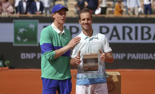 Italy's Jannik Sinner, left, stands by France's Richard Gasquet after their second round match of the French Tennis Open, at the Roland-Garros stadium, in Paris, Thursday, May 29, 2025. (AP Photo/Thibault Camus)