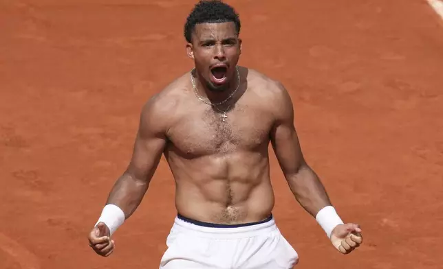 France's Arthur Fils celebrates beating Spain's Jaume Munar after their second round match of the French Tennis Open, at the Roland-Garros stadium, in Paris, Thursday, May 29, 2025. (AP Photo/Christophe Ena)