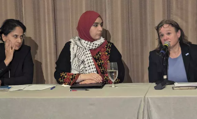 Mapheze Saleh, center, wife of arrested and detained Georgetown University scholar Badar Khan Suri, listens as senior immigrant rights attorney at ACLU Virginia Eden Heilman, right, speaks during a press conference about her husband's release following his hearing at Federal District Court for the Eastern District of Virginia, in Alexandria, Va., Thursday, May 14, 2025 (AP Photo/Nathan Ellgren)