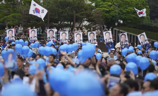 Supporters hold banners showing pictures of South Korea's Democratic Party's presidential candidate Lee Jae-myung during a presidential election campaign in Goyang, South Korea, Tuesday, May 20, 2025. (AP Photo/Lee Jin-man)