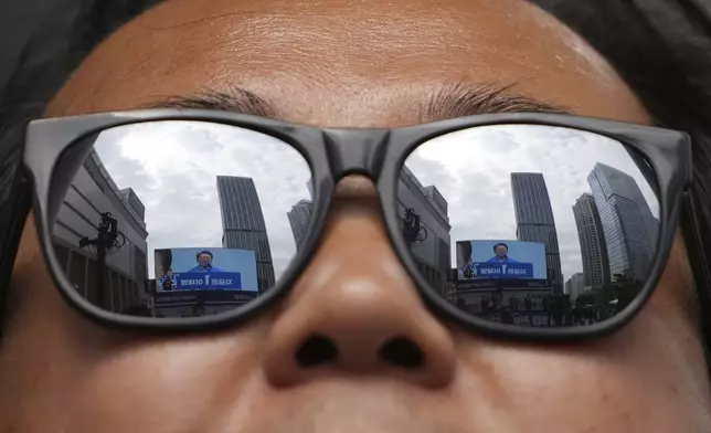 South Korea's Democratic Party's presidential candidate Lee Jae-myung is reflected on the glasses during a presidential election campaign in Seoul, South Korea, Monday, May 19, 2025. (AP Photo/Lee Jin-man)