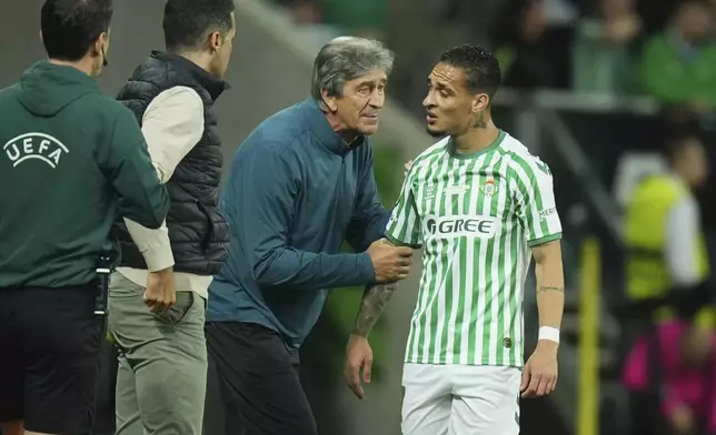 Betis' head coach Manuel Pellegrini talks to Antony during the Europa League final soccer match between Real Betis and Chelsea in Wroclaw, Poland, Wednesday, May 28, 2025. (AP Photo/Petr David Josek)