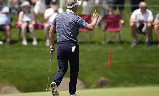 Luke Donald, of England, waves after making a putt on the 18th hole during the first round of the PGA Championship golf tournament at the Quail Hollow Club, Thursday, May 15, 2025, in Charlotte, N.C. (AP Photo/David J. Phillip)
