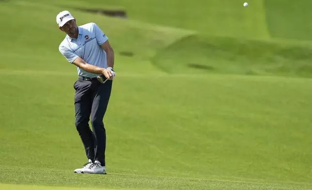 Keegan Bradley chips to the green on the 14th hole during the first round of the PGA Championship golf tournament at the Quail Hollow Club, Thursday, May 15, 2025, in Charlotte, N.C. (AP Photo/Matt York)