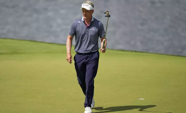 Luke Donald, of England, waves after making a putt on the 14th hole during the first round of the PGA Championship golf tournament at the Quail Hollow Club, Thursday, May 15, 2025, in Charlotte, N.C. (AP Photo/Matt York)