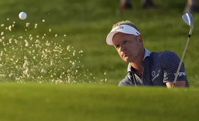 Luke Donald, of England, hits from the bunker on the first hole during the first round of the PGA Championship golf tournament at the Quail Hollow Club, Thursday, May 15, 2025, in Charlotte, N.C. (AP Photo/George Walker IV)