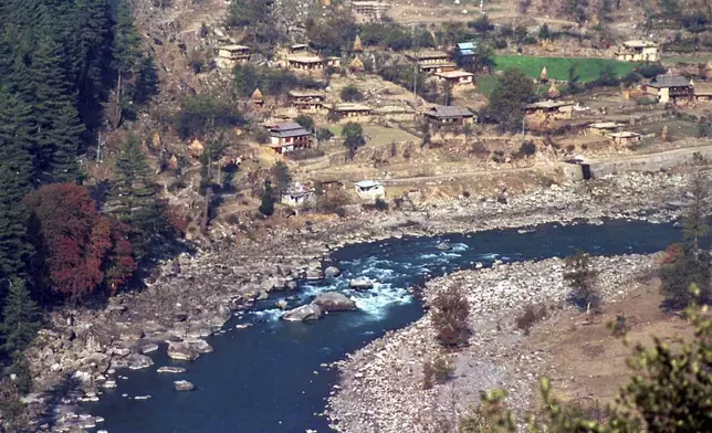 FILE - A Pakistan administered Kashmir village is seen from the Indian border along the Kishan Ganga river on the dividing line of the Line of Control which divides India and Pakistan in the Keran Sector, some 166kms (101 miles) northwest of Srinagar, India Monday, Nov. 6, 2000. (AP Photo/Aijaz Rahi, File)