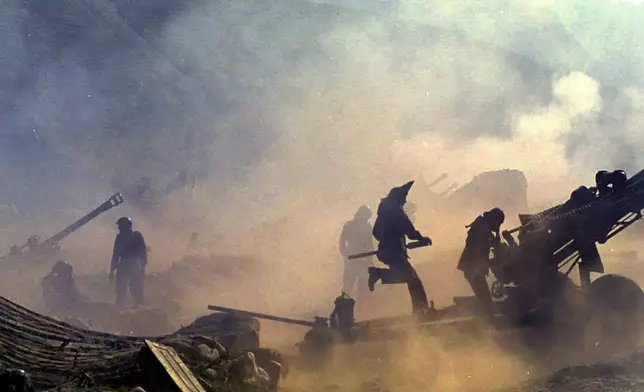 FILE - Indian artillery guns are engulfed in smoke in Dras, some 155 kilometers (96 miles) north of Srinagar, India, as Indian troops fight Pakistani intruders in the disputed Kashmir on July 10, 1999. (AP Photo/Aijaz Rahi, File)
