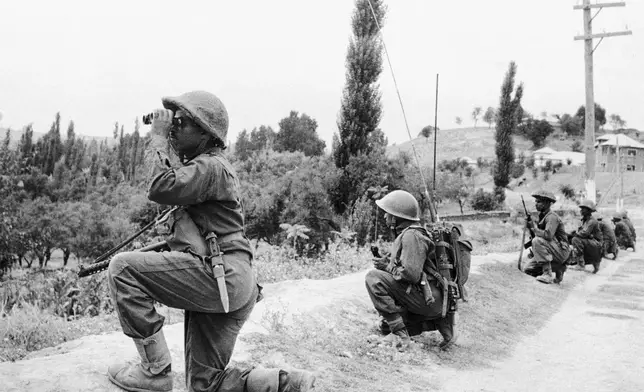 FILE - Indian troops are on the move in Kashmir against guerrilla forces during the second war over Kashmir on Sept. 6, 1965. (AP Photo, File)