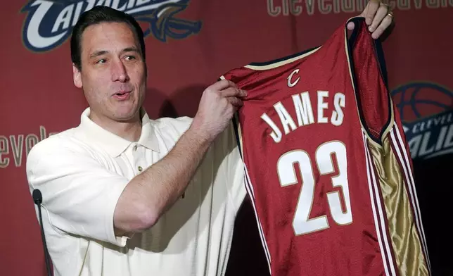 FILE - Cleveland Cavaliers General Manager Jim Paxson holds up the No. 23 jersey with LeBron James' name on the back during an NBA basketball news conference at Gund Arena in Cleveland Friday, May 23, 2003.. (AP Photo/Mark Duncan, File)
